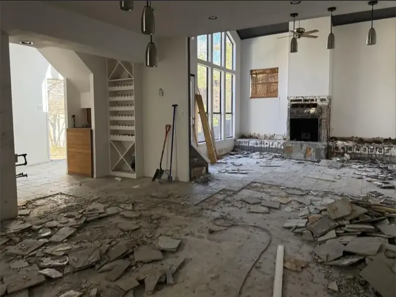 Sala com piso removido e lareira aberta durante a reforma